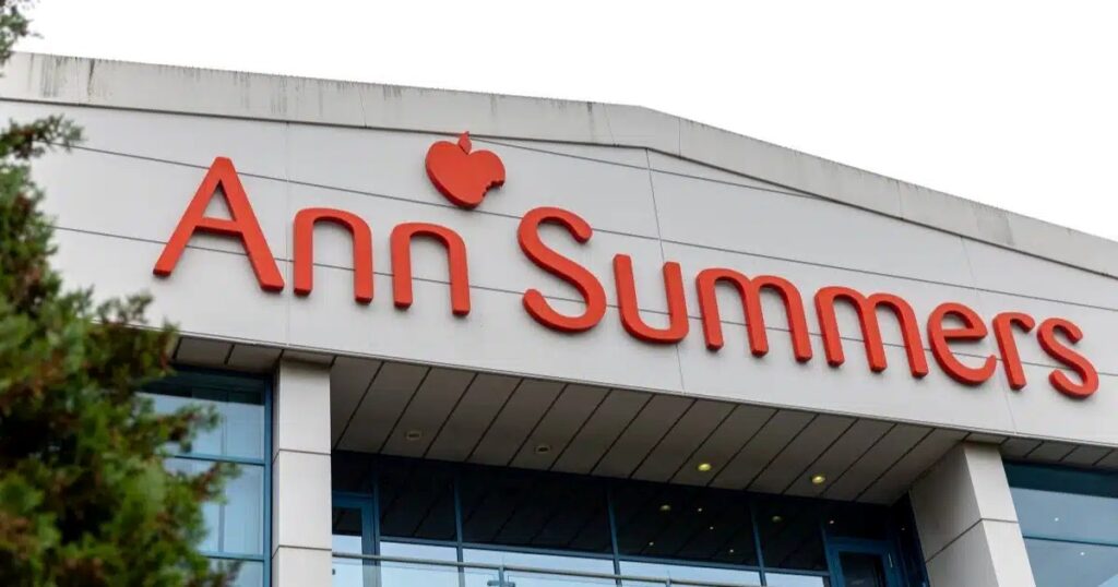 The outside of a large grey cladded office block with Ann Summers in red lettering displayed