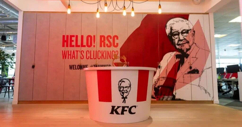 Inside of the KFC UK headquarters in Woking, Surrey. A large red and white bucket stands at the front of the image.